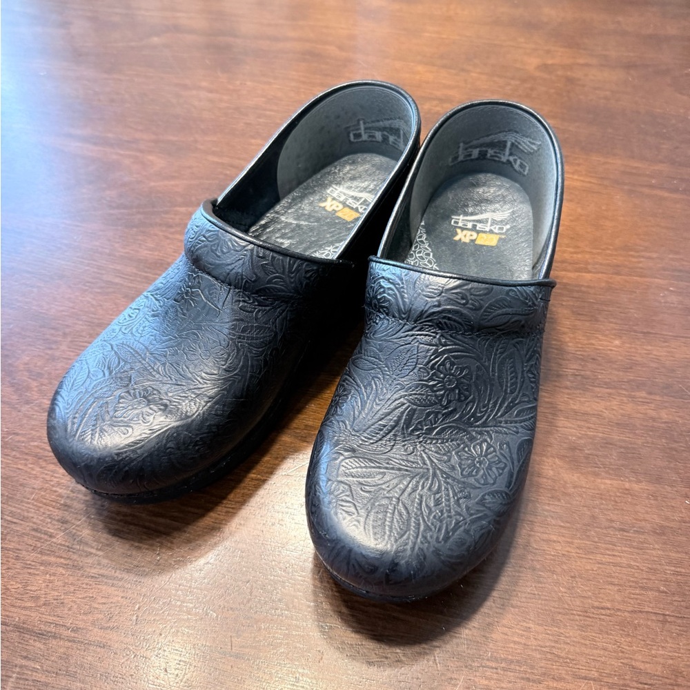 Dansko Black Slip-On Clogs with Embossed Pattern